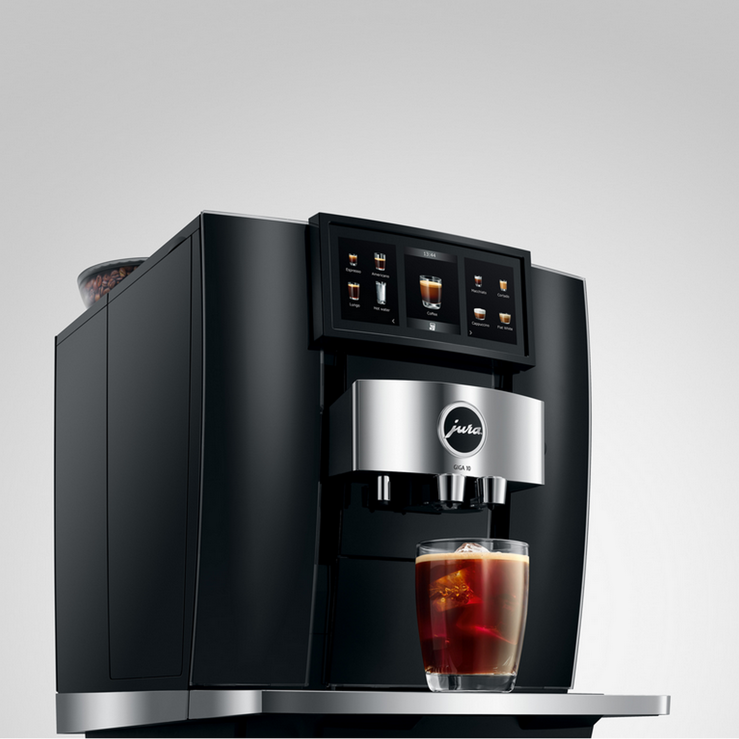 Black coffee machine with touch screen and glass of iced coffee.