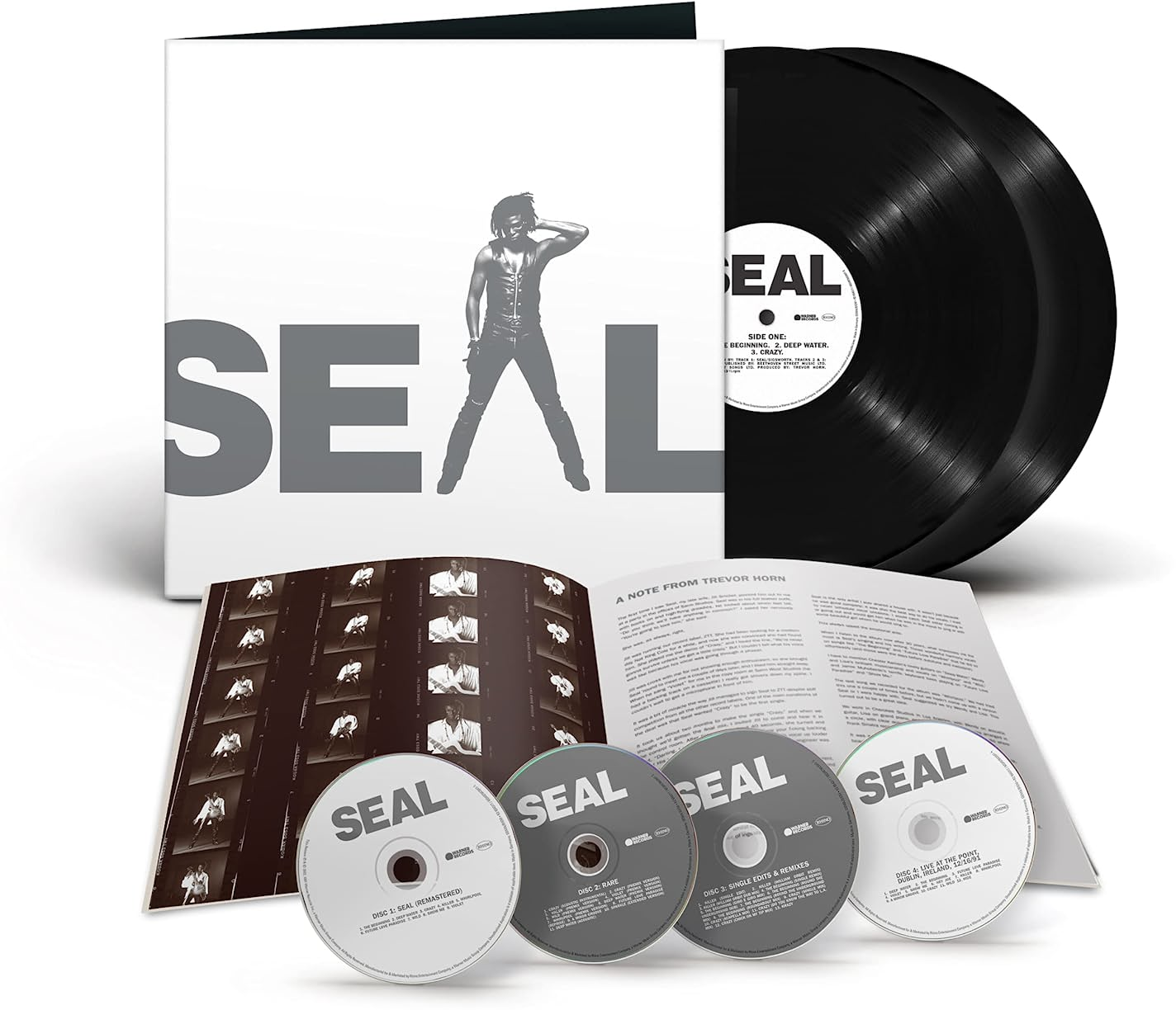Albumkészlet bakelit lemezekkel, CD-kkel és füzettel. Az albumborítón Seal látható. Fekete lemezek és CD-k láthatók.