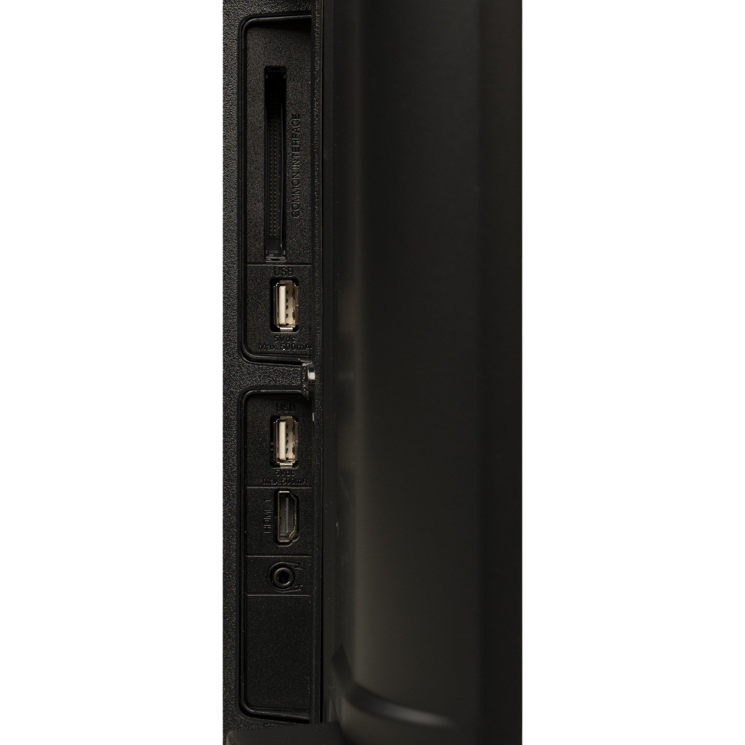 Close-up of the back of a TV with USB, HDMI, and other connection ports on a black background.
