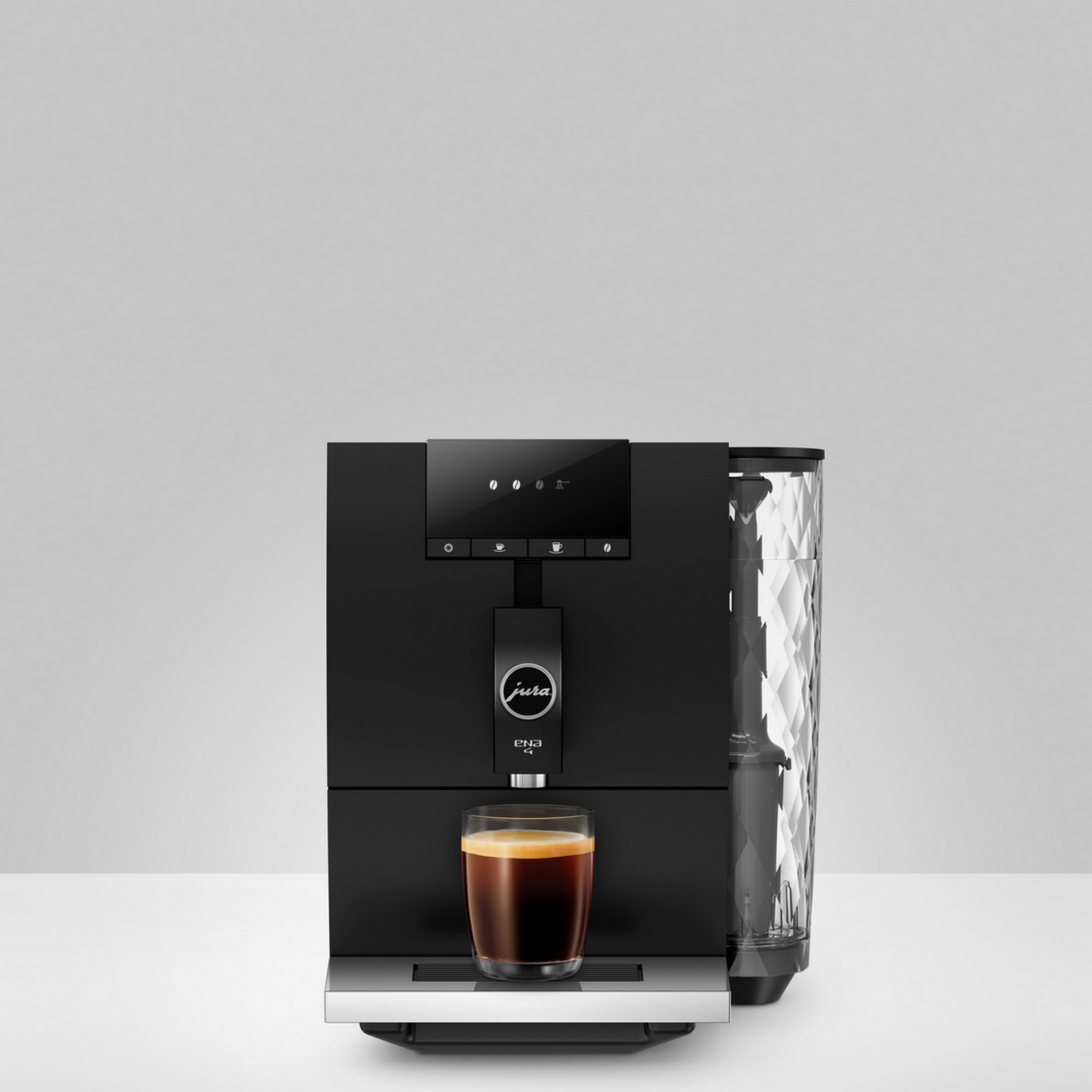 Black Jura coffee machine. A glass of coffee sits on the tray. The water container is visible.