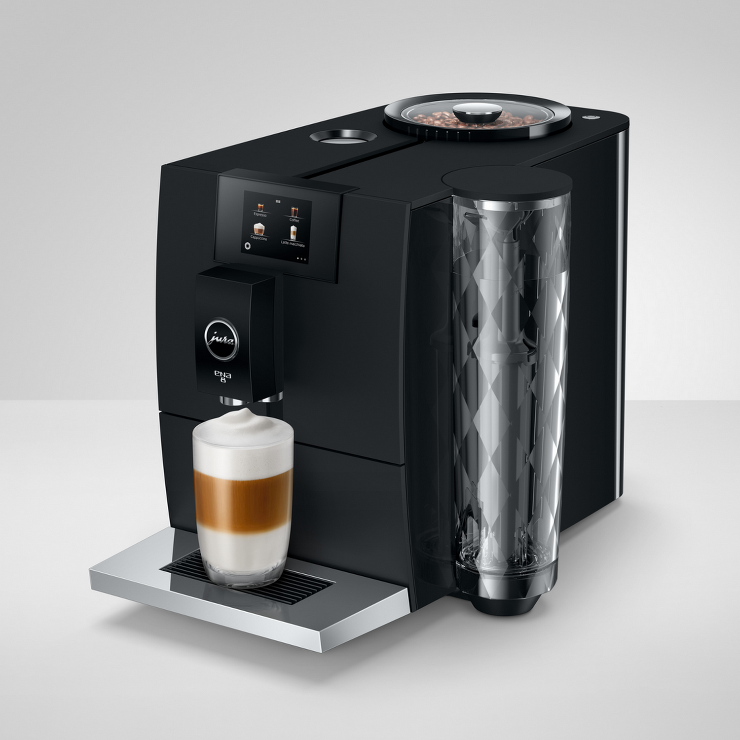 Black Jura coffee machine with a glass of latte. White background, modern design.