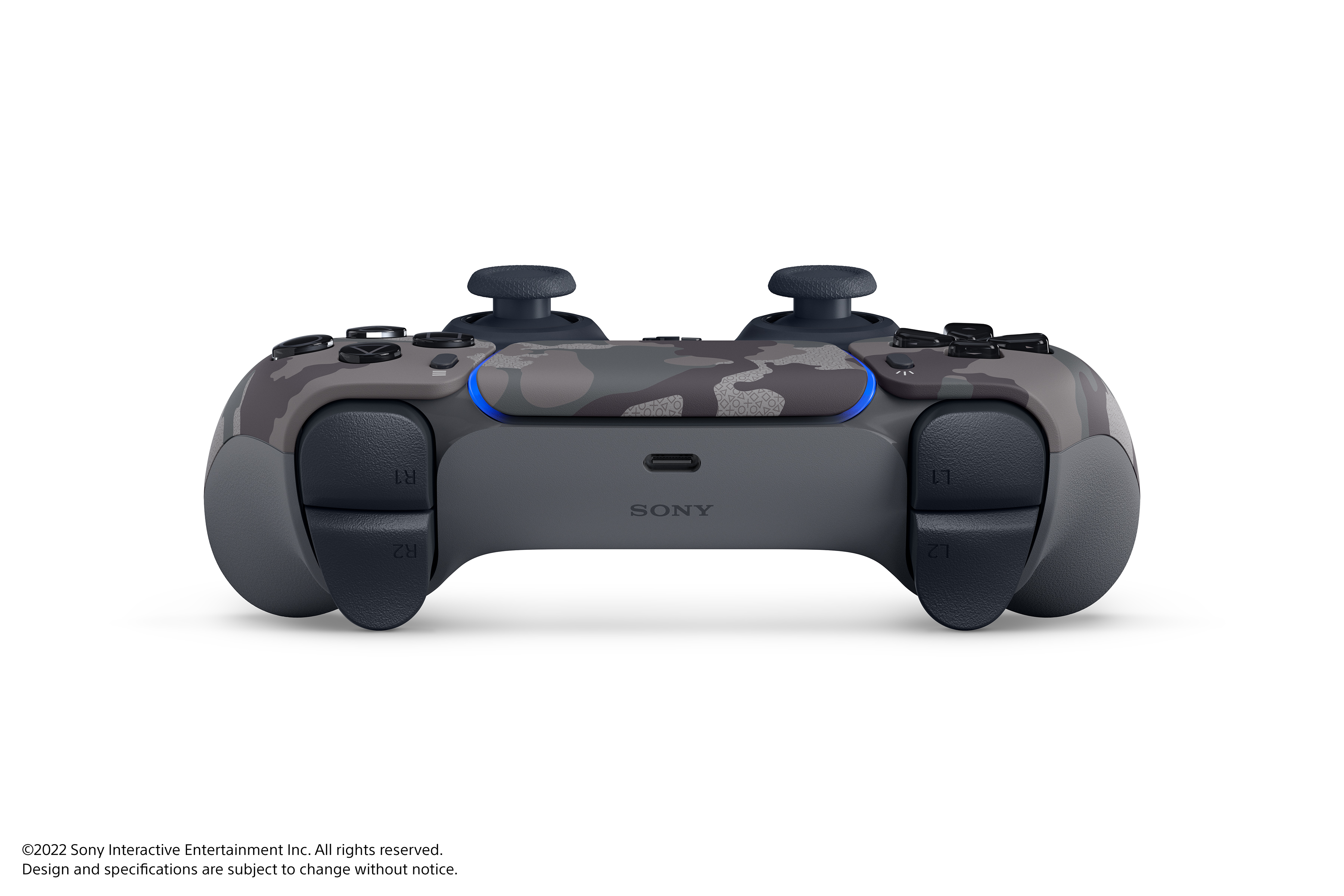 Ein grauer Tarnmuster-Controller mit blauem Licht und dem Sony-Logo darauf.