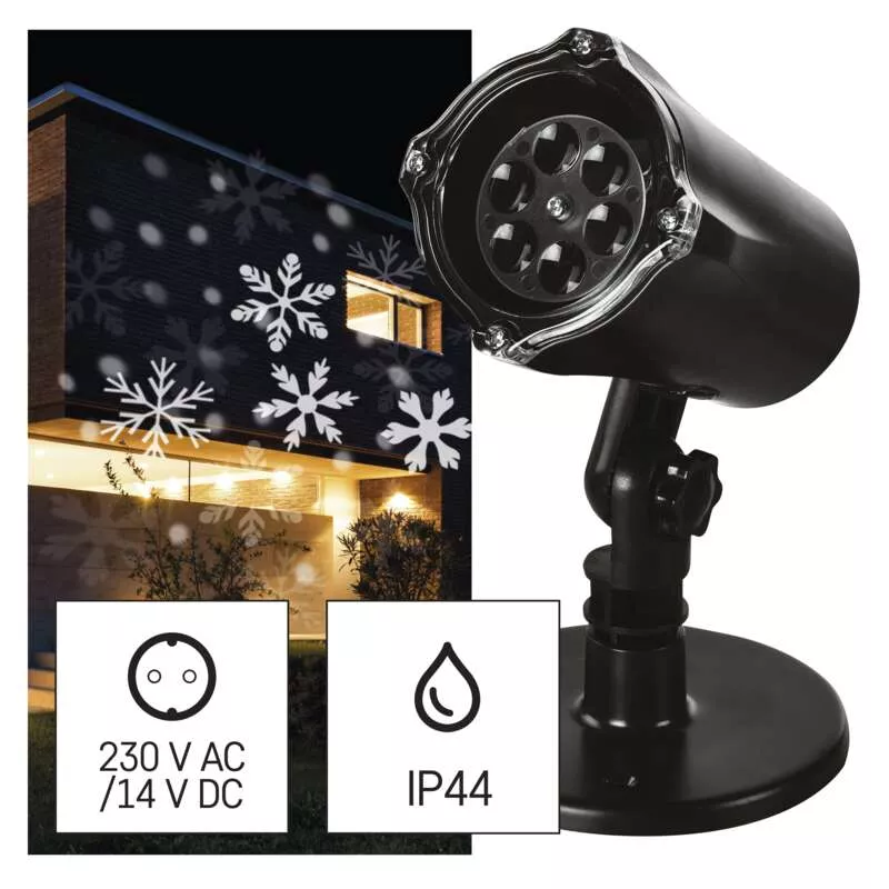Fekete projektor, amely hópihéket vetít egy házra. A szöveg 230V AC/14V DC és IP44.