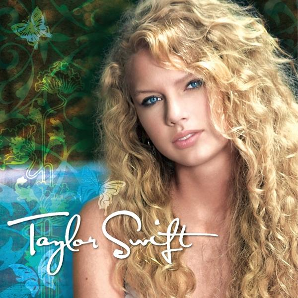 Albumborító Taylor Swift-tel, hosszú szőke hajjal és kék szemekkel, virágos elemekkel körülvéve.