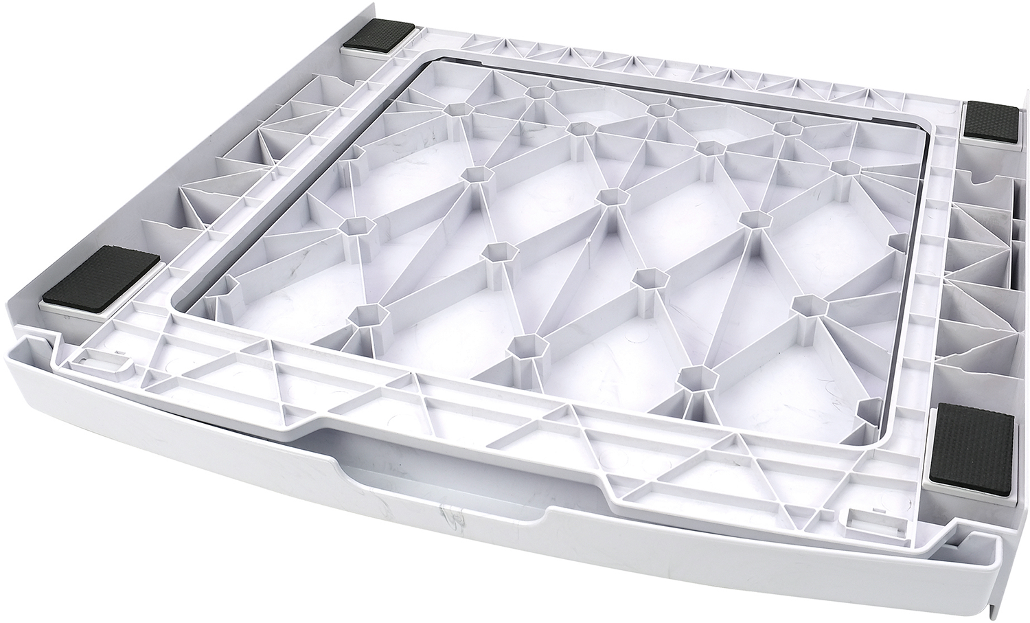 Underside view of a white appliance base with a honeycomb pattern.
