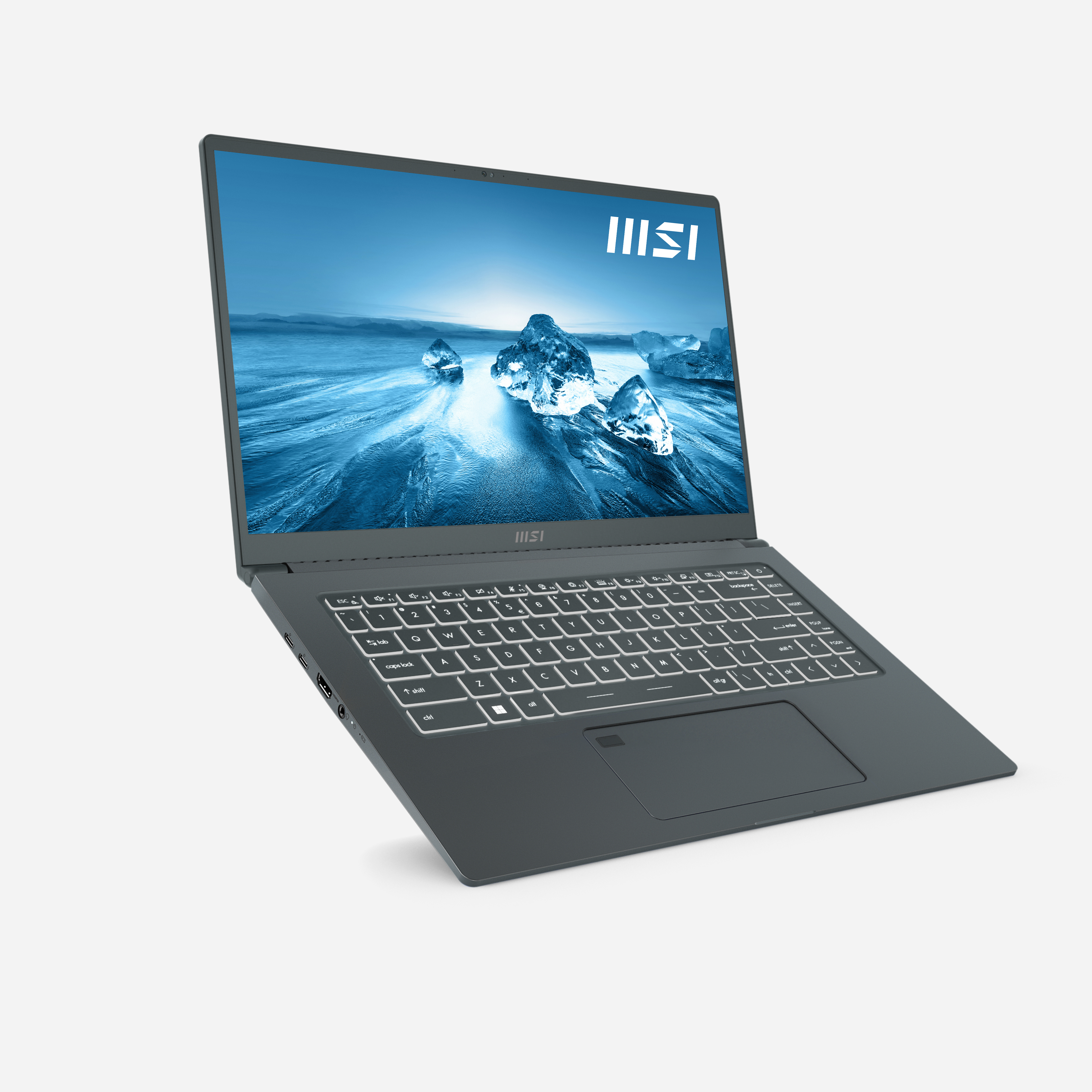 Portátil MSI sobre una superficie blanca. Es gris oscuro, abierto, mostrando el teclado y la pantalla.