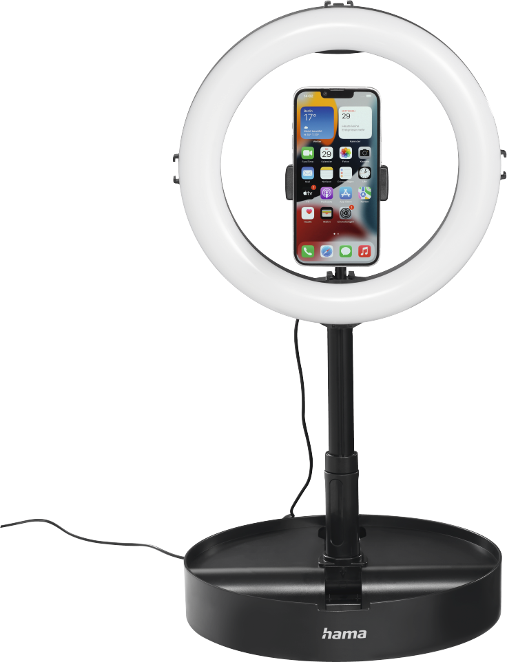 Una luce ad anello con un supporto per telefono. Un telefono è montato. Base e supporto sono neri. Luce bianca intorno.