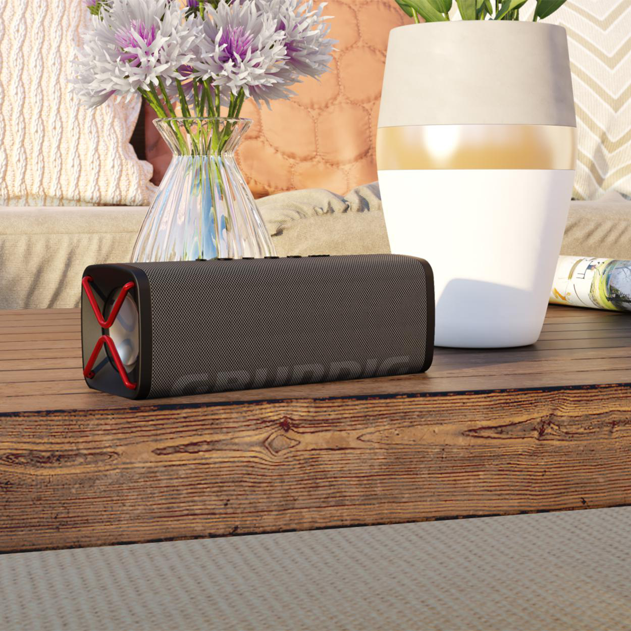 Ein schwarzer Lautsprecher mit roten Akzenten und eine weiße Vase auf einem Holztisch mit Blumen.