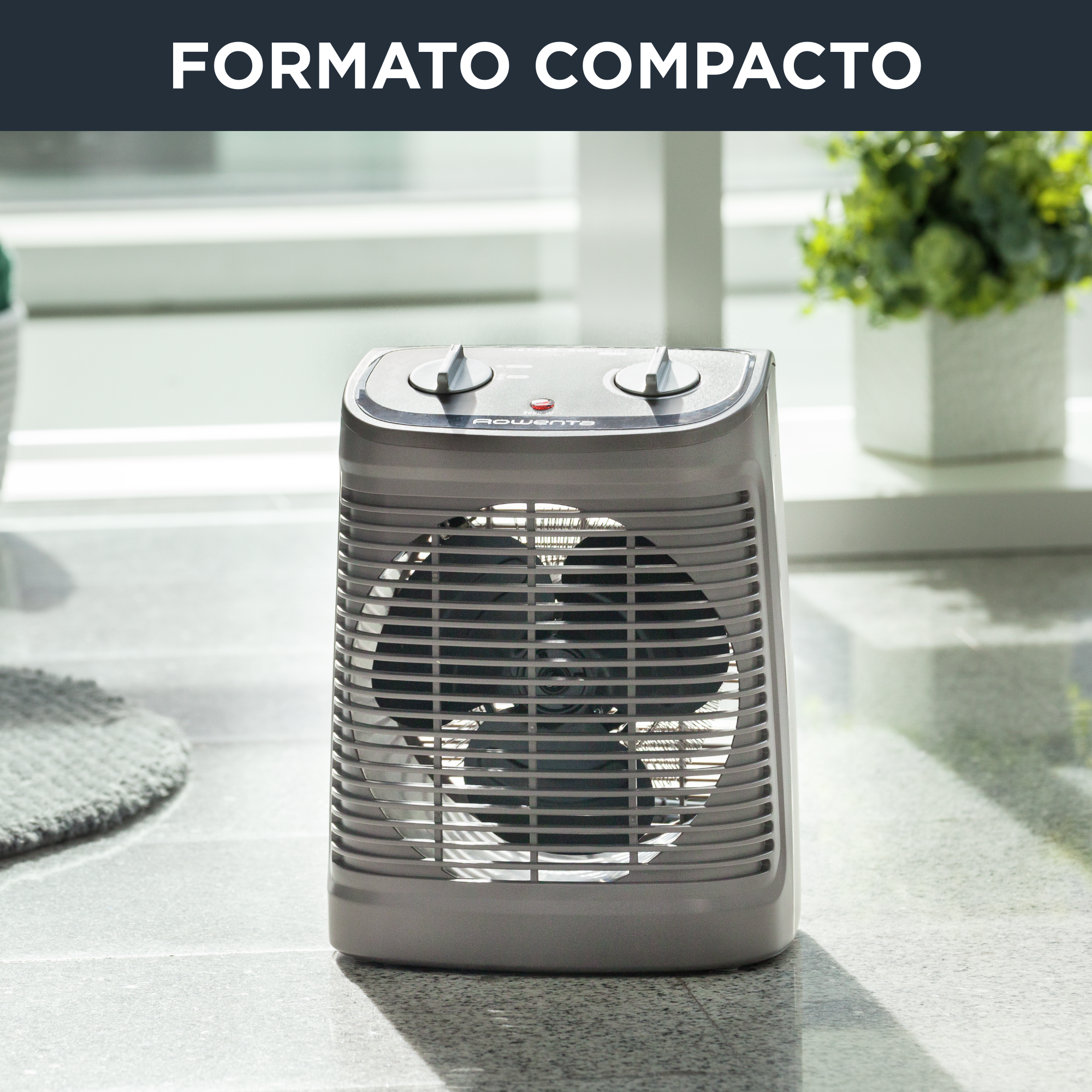 Un calefactor compacto en una habitación. Hay una ventana y algunas plantas en el fondo.