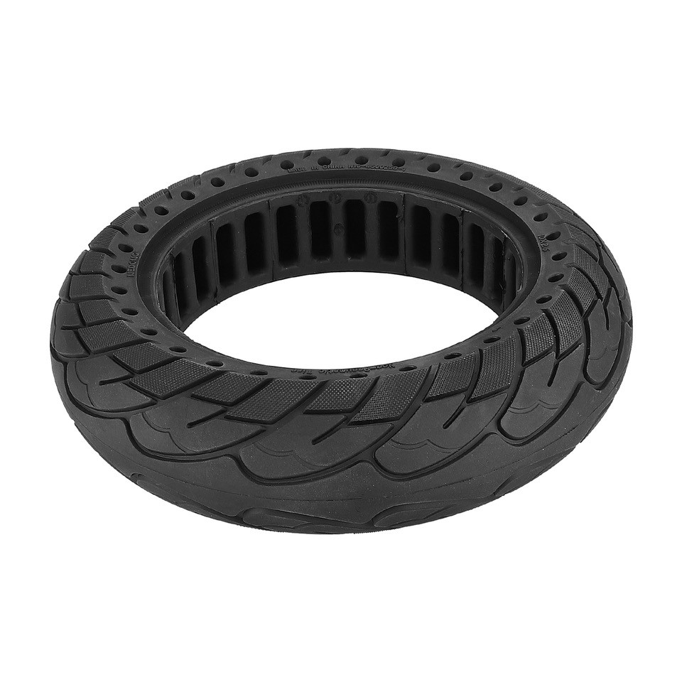 Un neumático de scooter negro y circular con dibujo de la banda de rodadura, aislado sobre fondo blanco.