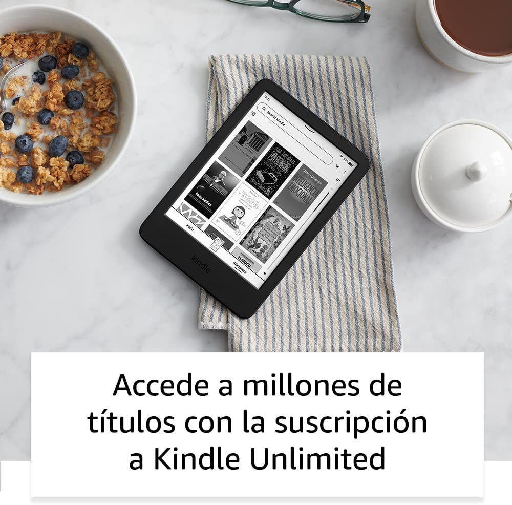 Un lector electrónico Kindle en una toalla, con un cuenco de cereales y una taza de café. Muestra portadas de libros.