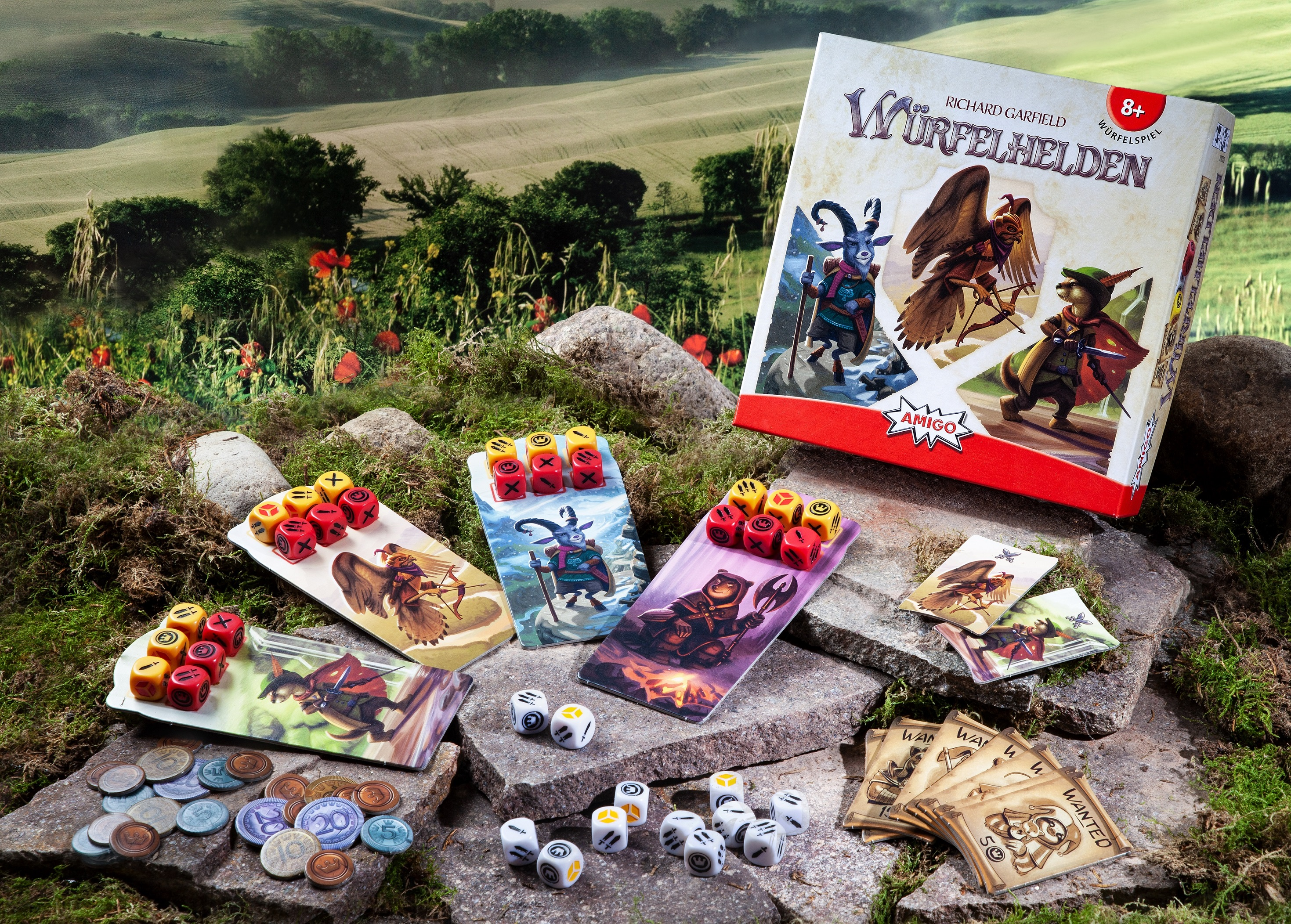 Brettspiel-Set mit bunten Spielsteinen auf Steinen und Gras. Auf der Box steht 'WÜRELFELDHELDEN'.