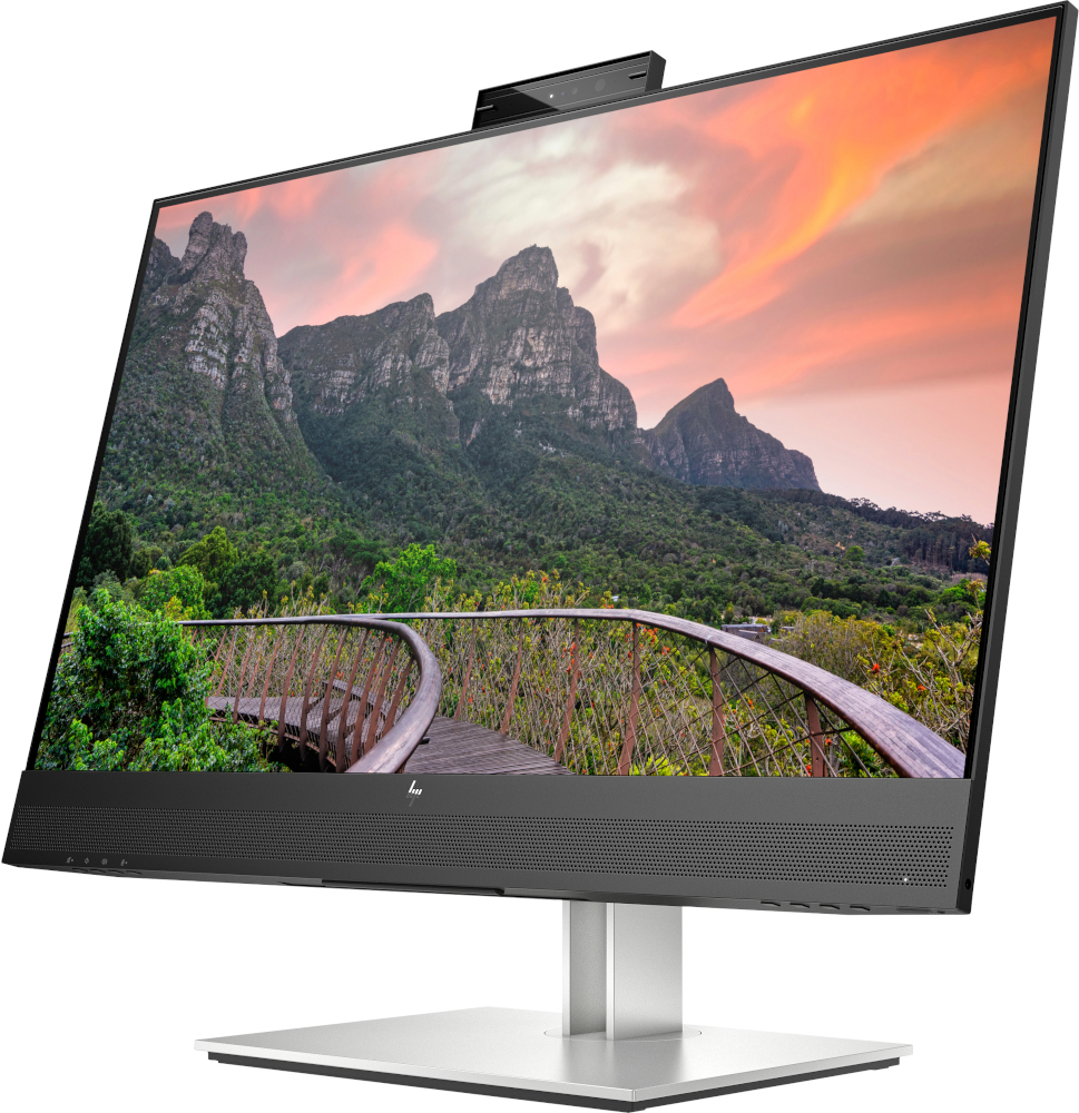 An all-in-one computer with a curved screen, displaying a scenic mountain and sky landscape.