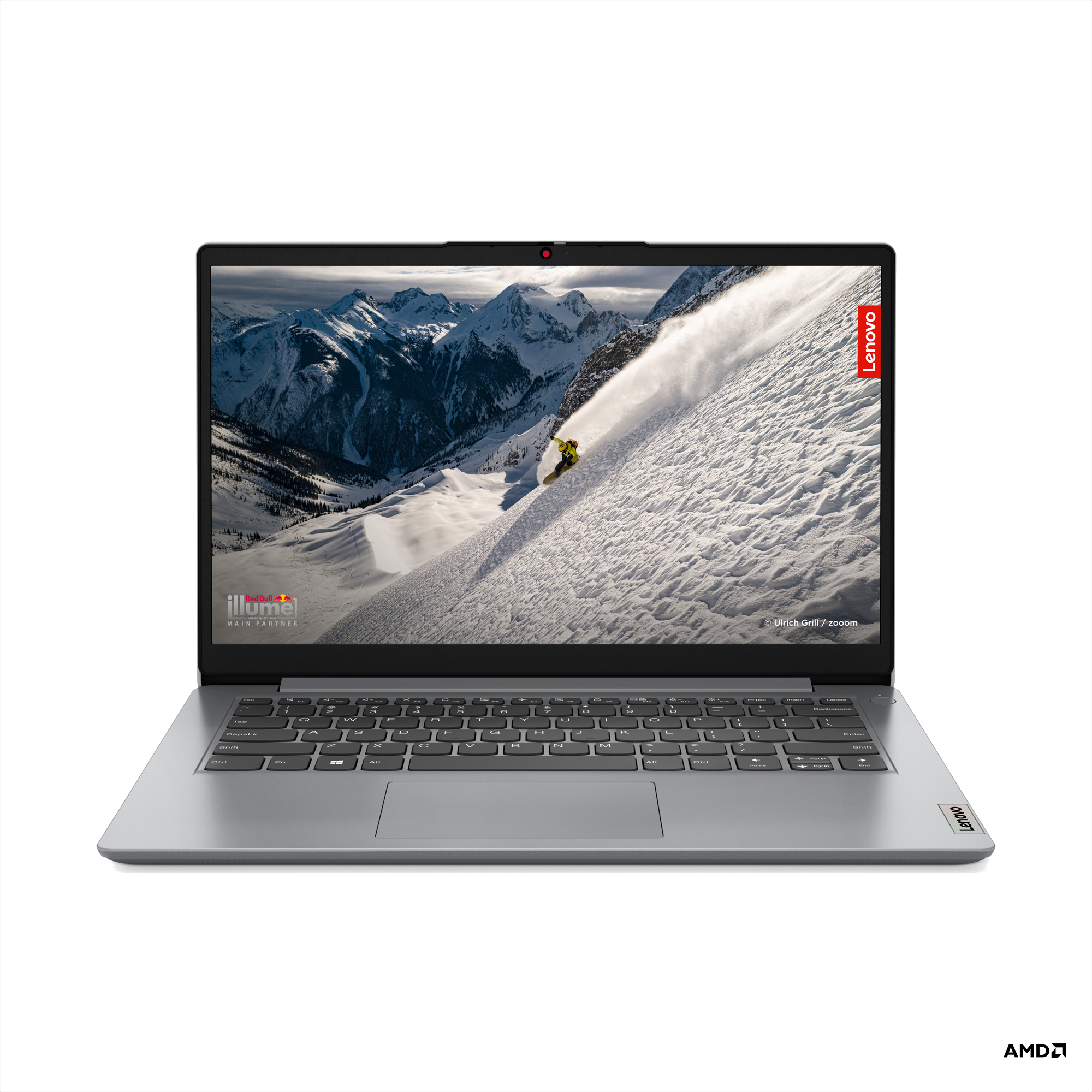 Dizüstü bilgisayar, ekranında karlı bir dağda kayakçı var. Sağ üstte Lenovo logosu.