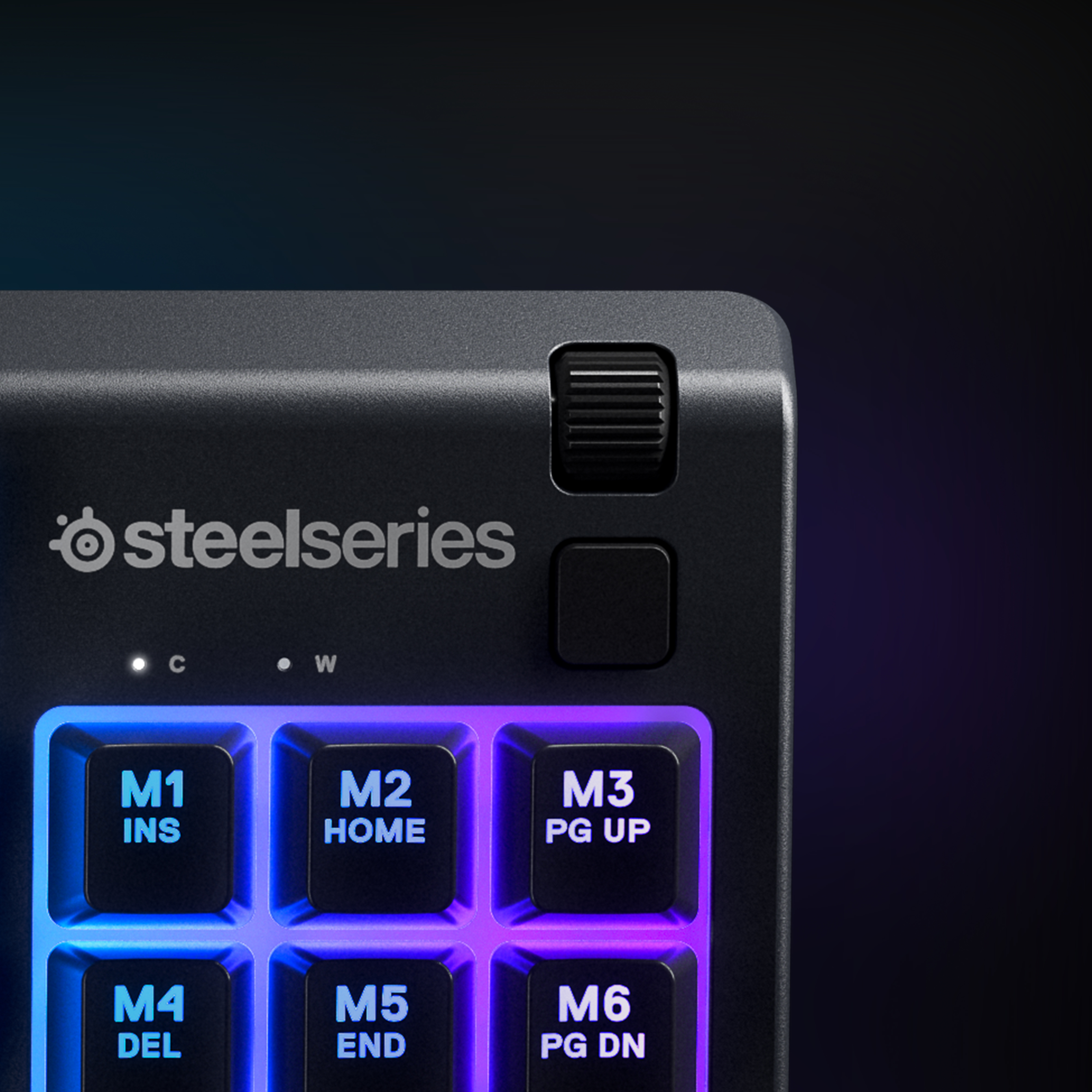 Close-up of a SteelSeries keyboard with illuminated keys, and control buttons, with the SteelSeries logo.