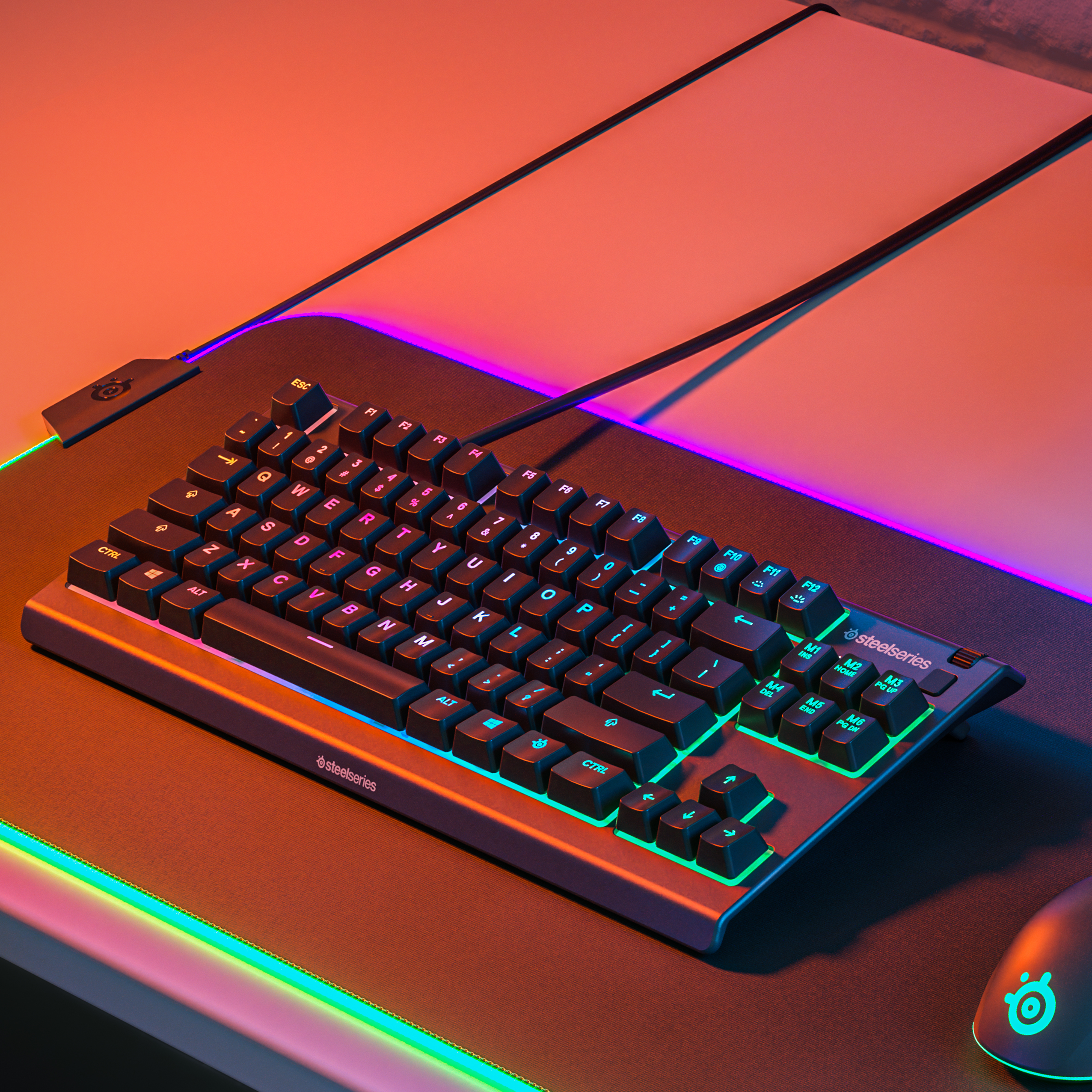Keyboard with lights, mouse and mousepad on a table.