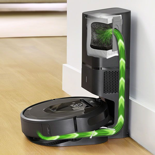 Roboter-Staubsauger auf Ladestation. Grüne Linien zeigen den Saugpfad.