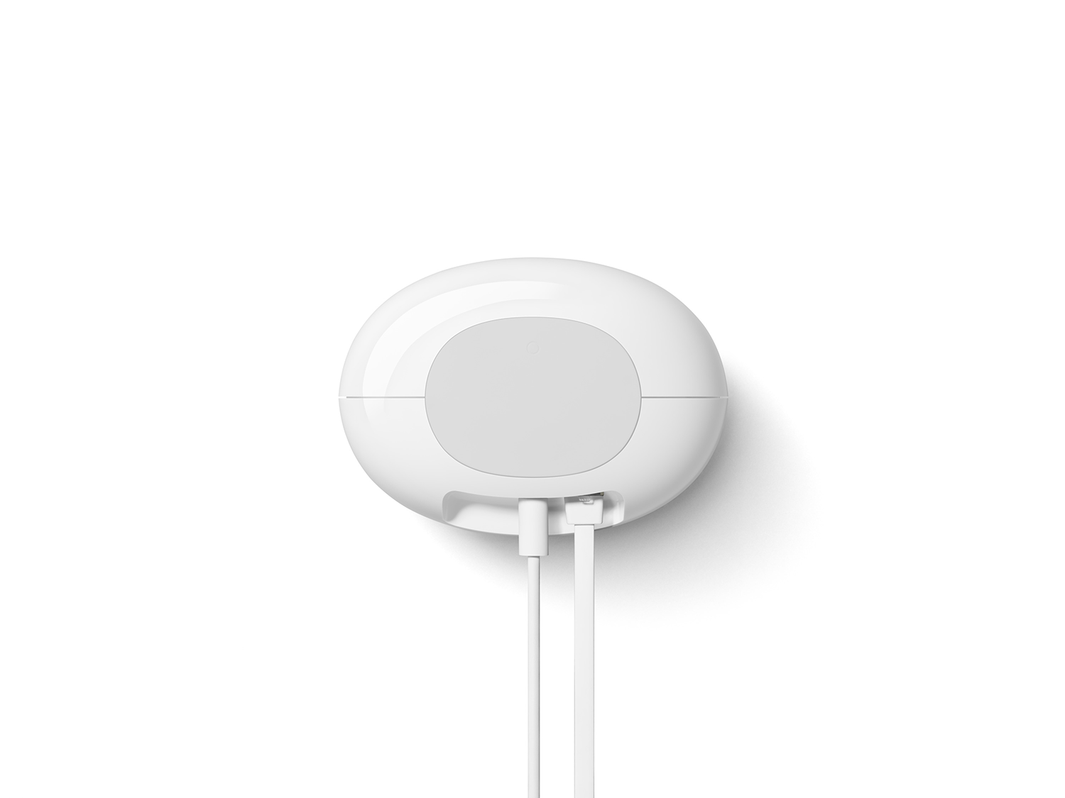 Wit, ovaalvormig apparaat met twee witte snoeren. Het apparaat heeft een lichtgrijs midden.