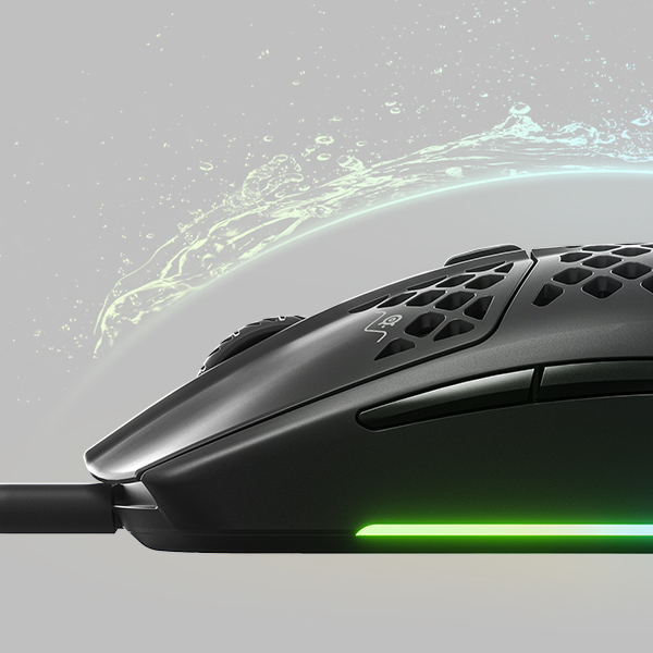Black gaming mouse with a honeycomb design and green light.  Water splash effect.