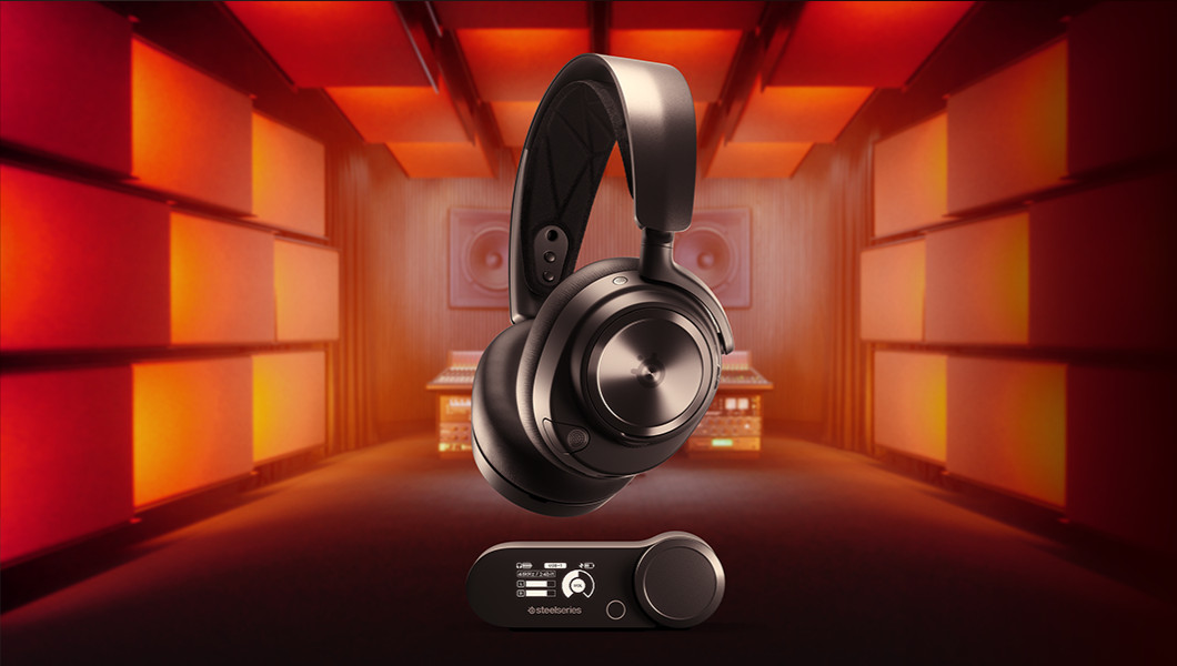 Black headphones with a control module. Red and orange lit background in a studio setting.