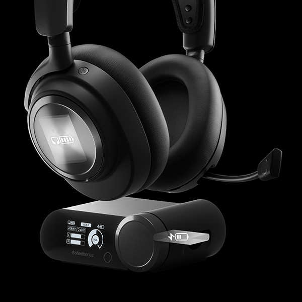 Black headset with a microphone and a charging dock, set against a dark backdrop.