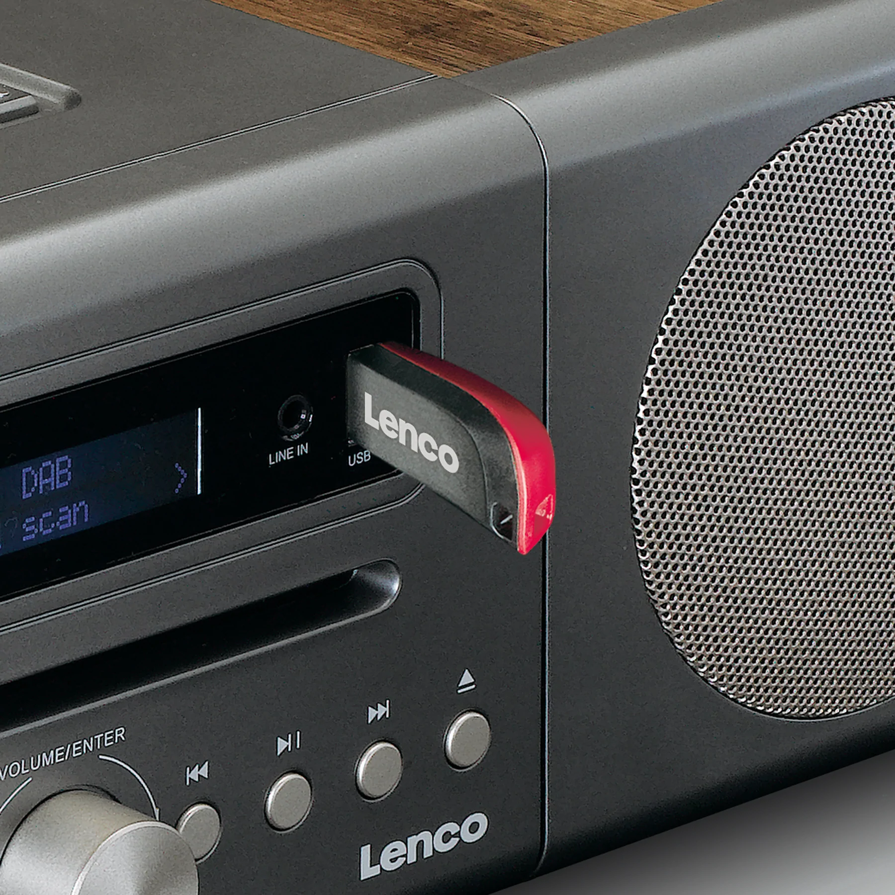 Nahaufnahme eines Radios mit einem Lenco USB-Stick. Das Radio ist schwarz mit einer Holzplatte.