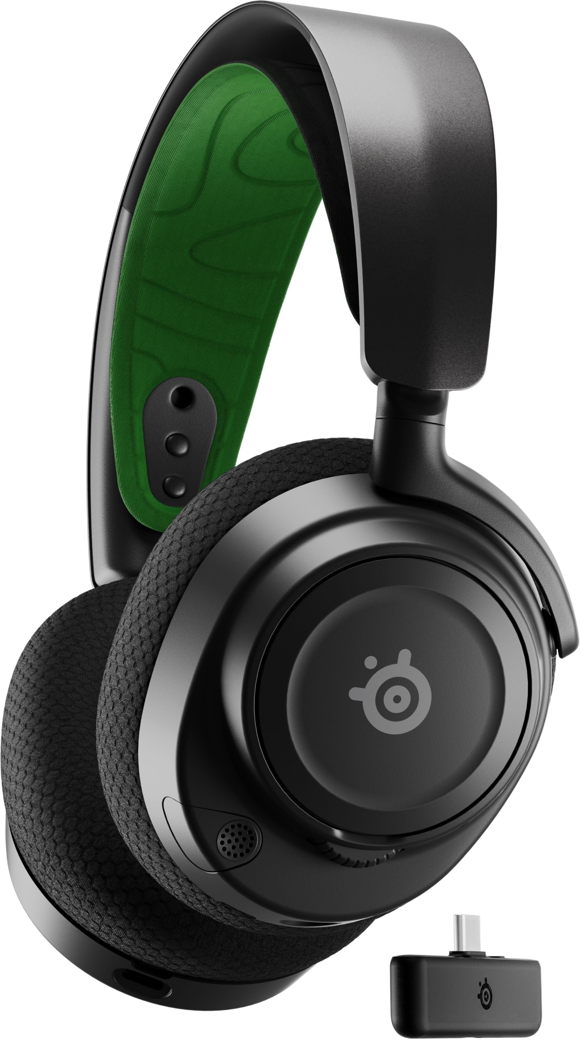 Casque noir et vert avec un adaptateur sans fil, incliné vers la droite.