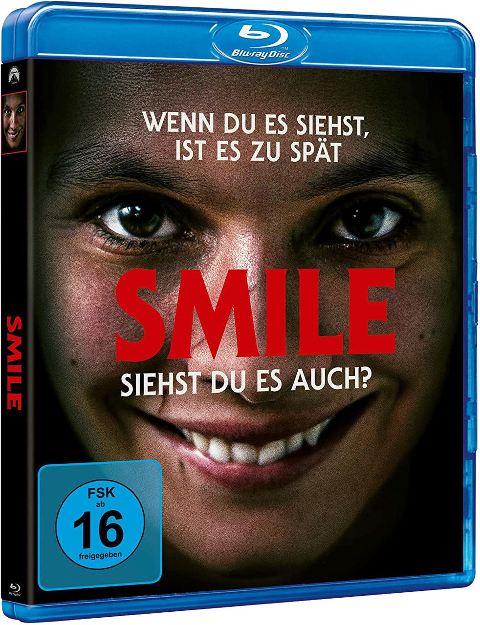 Blu-ray-Disc-Cover mit Nahaufnahme eines lächelnden Gesichts und dem Titel 'SMILE'.