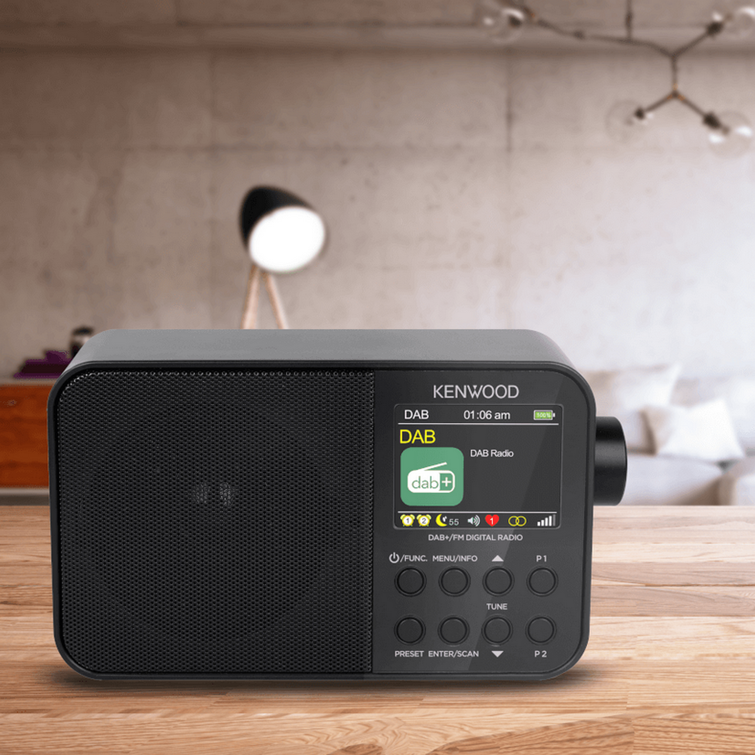 A black Kenwood DAB radio on a wooden surface.