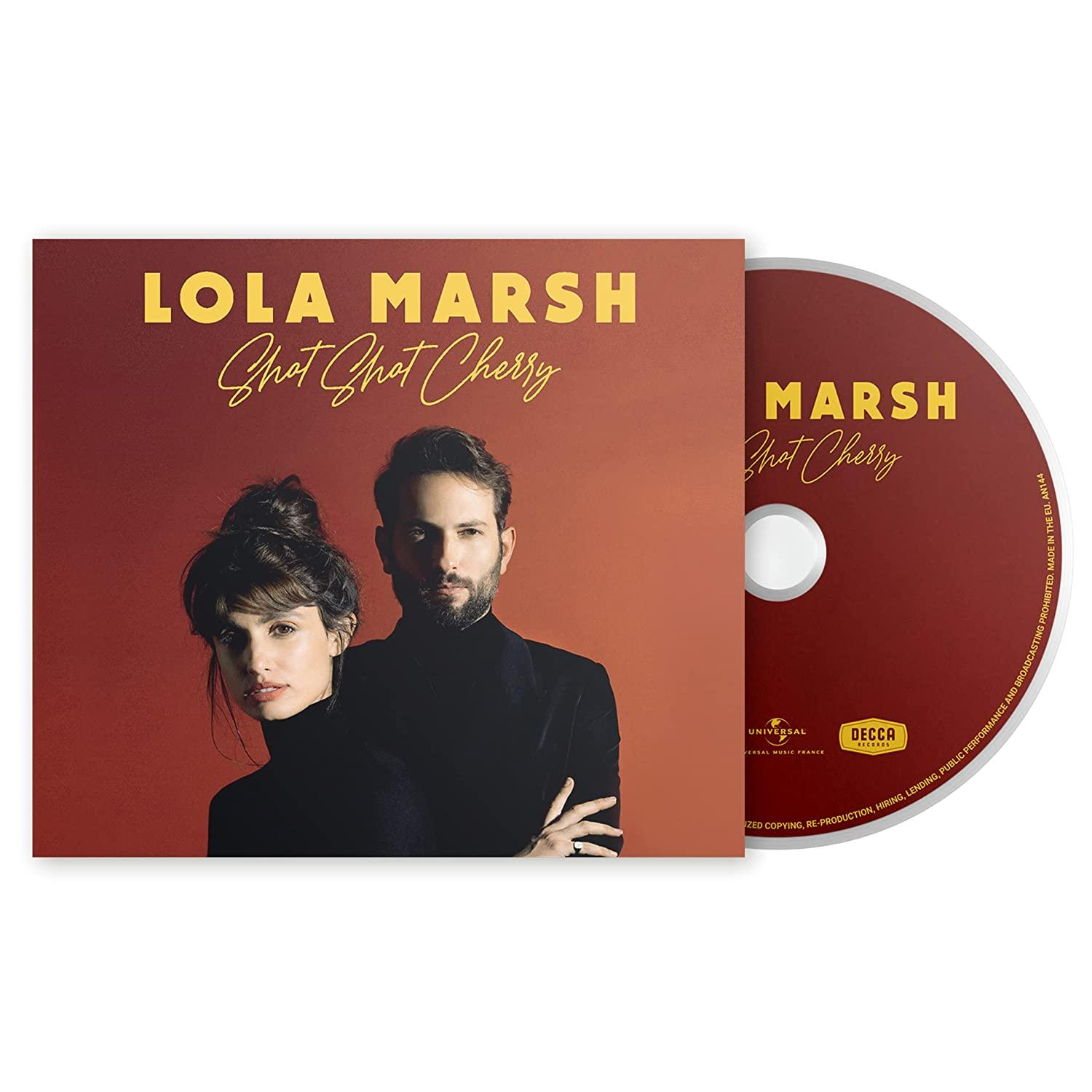 Albumcover mit zwei Personen. Eine ist eine Frau mit Dutt, der andere ein Mann. Rötlicher Hintergrund.