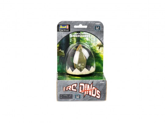 Spielzeug-Dinosaurier in einer eiförmigen Verpackung auf weißem Grund.