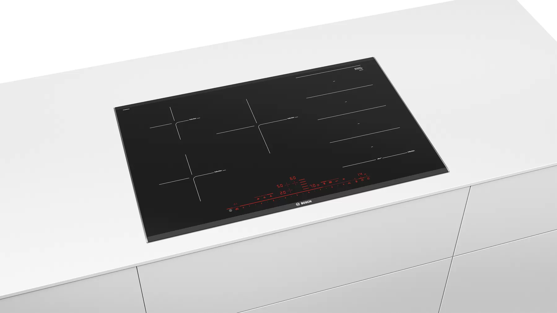 Une table de cuisson à induction noire sur une surface blanche. Elle a quatre zones de cuisson.