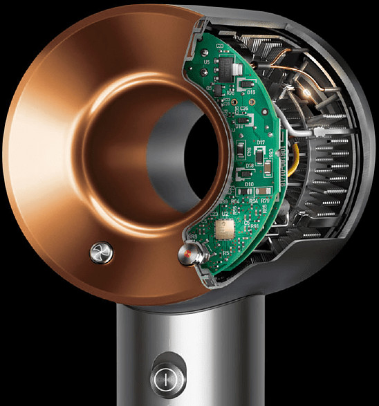 Close-up of a hair dryer's internal components, including circuit boards and a copper-colored outer ring.