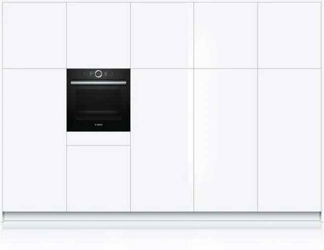 Meubles de cuisine blancs avec un four noir au milieu.