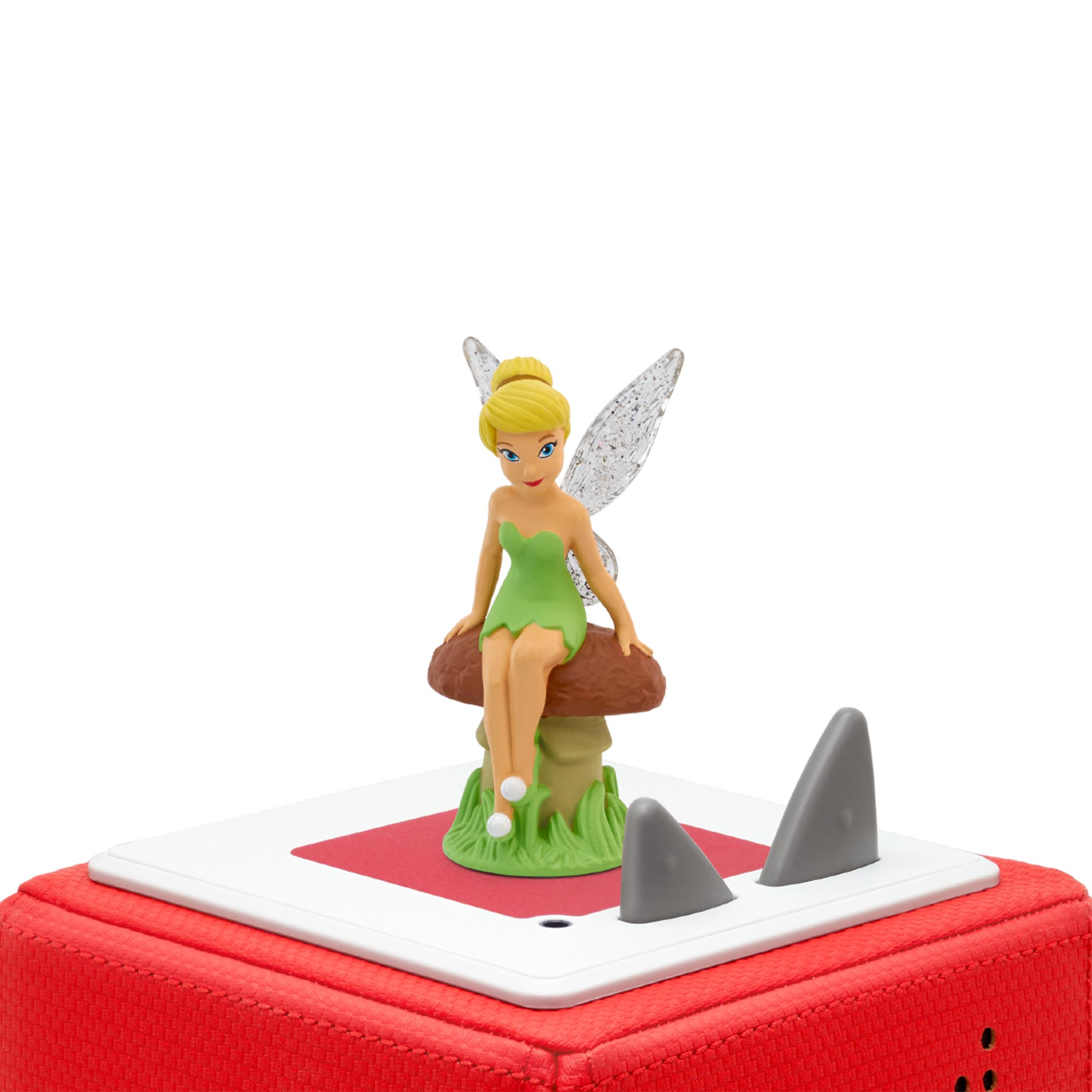 Tinkerbell-Figur sitzt auf einem Pilz auf roter Basis mit Haifischflossen.