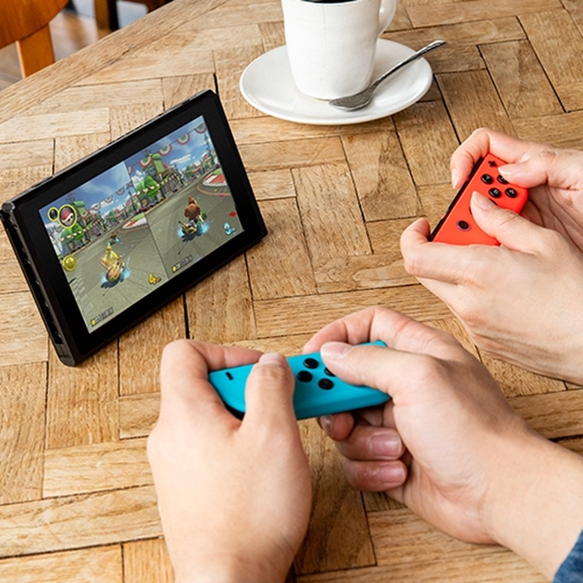 Two people playing a game on a Nintendo Switch, with controllers.