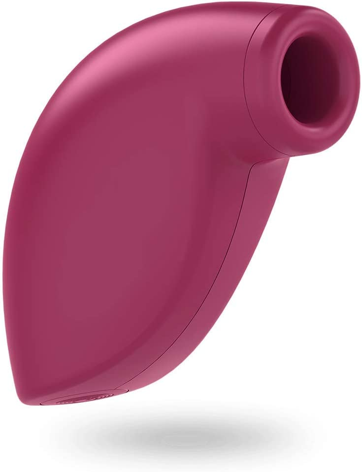 Un juguete sexual de color magenta se muestra sobre un fondo blanco.
