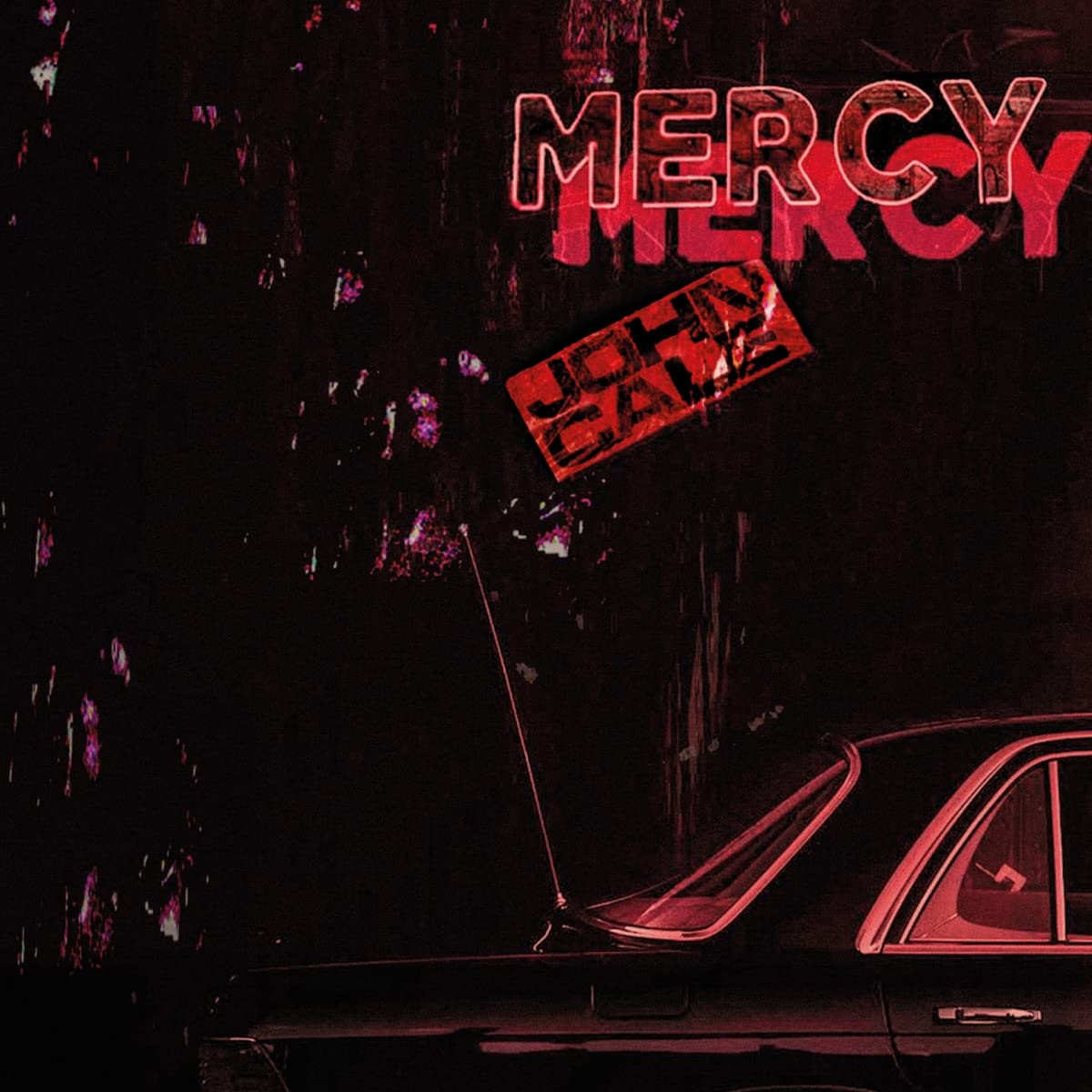 Album borító. Neon piros 'Mercy' felirat, autó az előtérben és sötét háttér.
