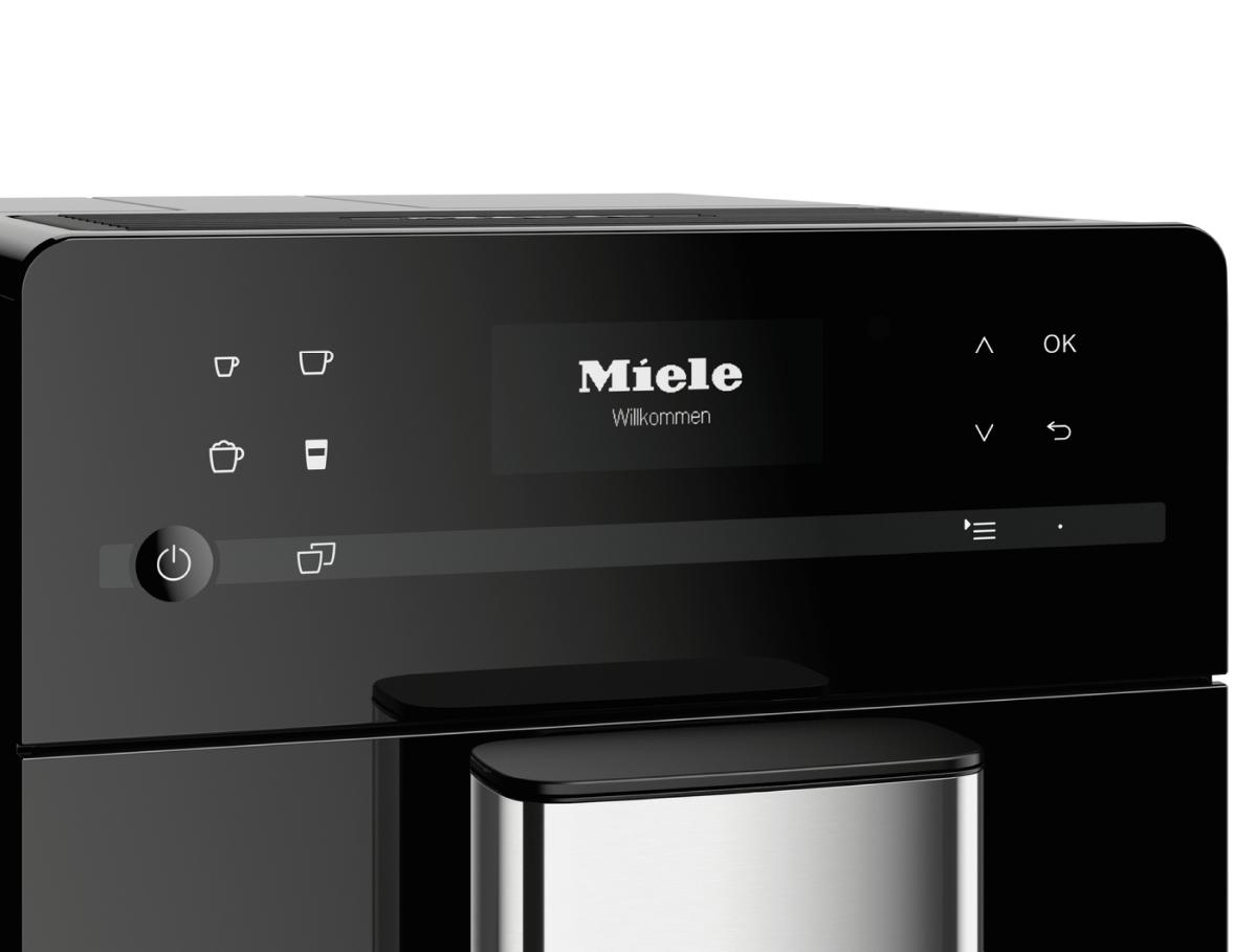 Schwarzes Miele-Kaffeemaschinenschnittstelle mit Bildschirm, Knöpfen und dem Wort Miele.