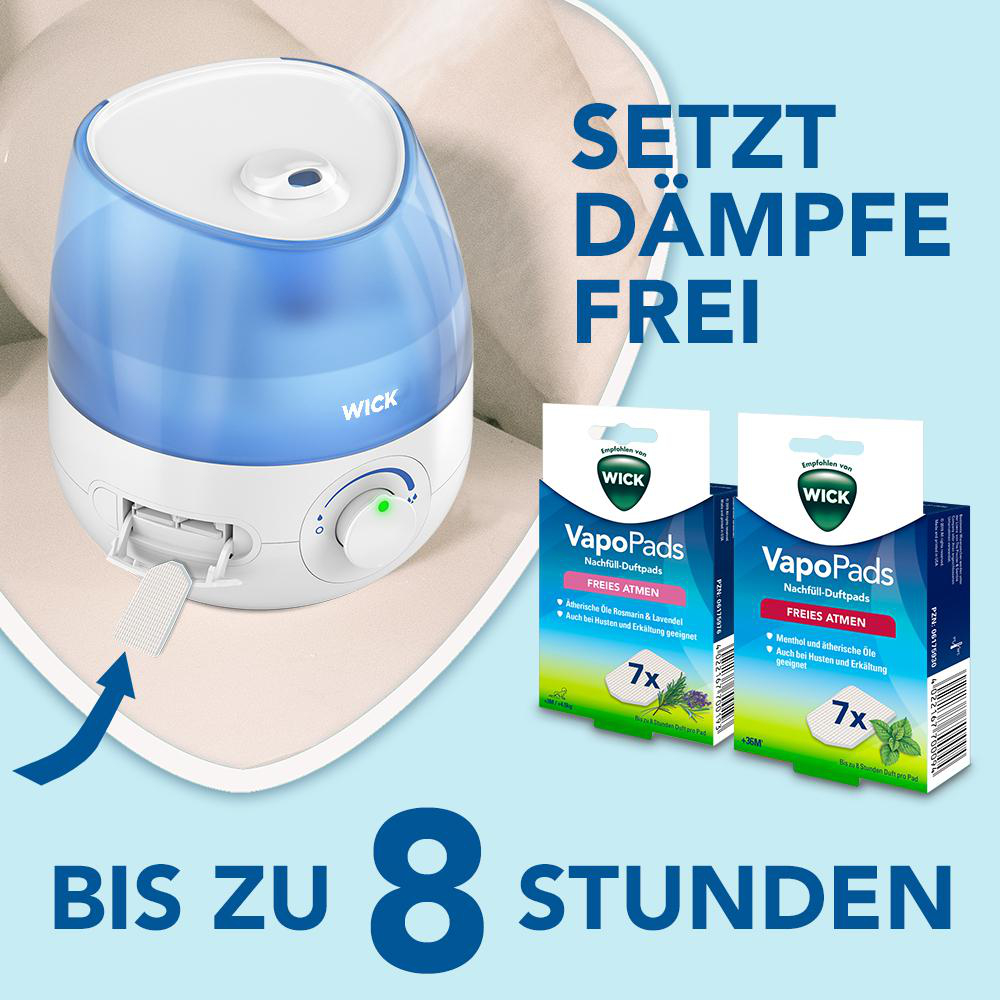 Luftbefeuchter mit zwei VapoPads-Boxen mit Text. Der Text lautet: 'SETZT DÄMPFE FREI'.