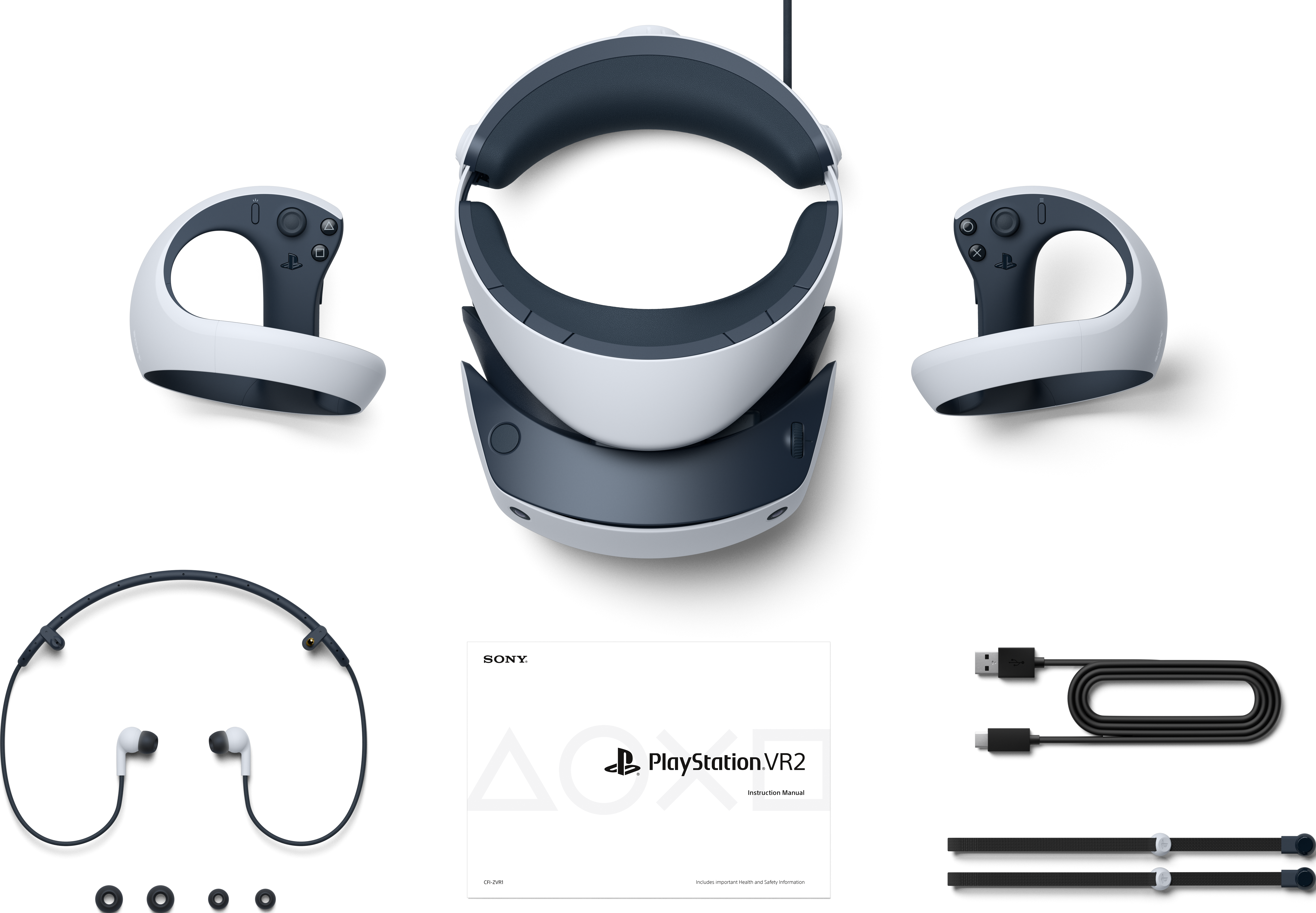 Ein VR-Headset, zwei Controller und weiteres Zubehör, angeordnet auf einer weißen Oberfläche.