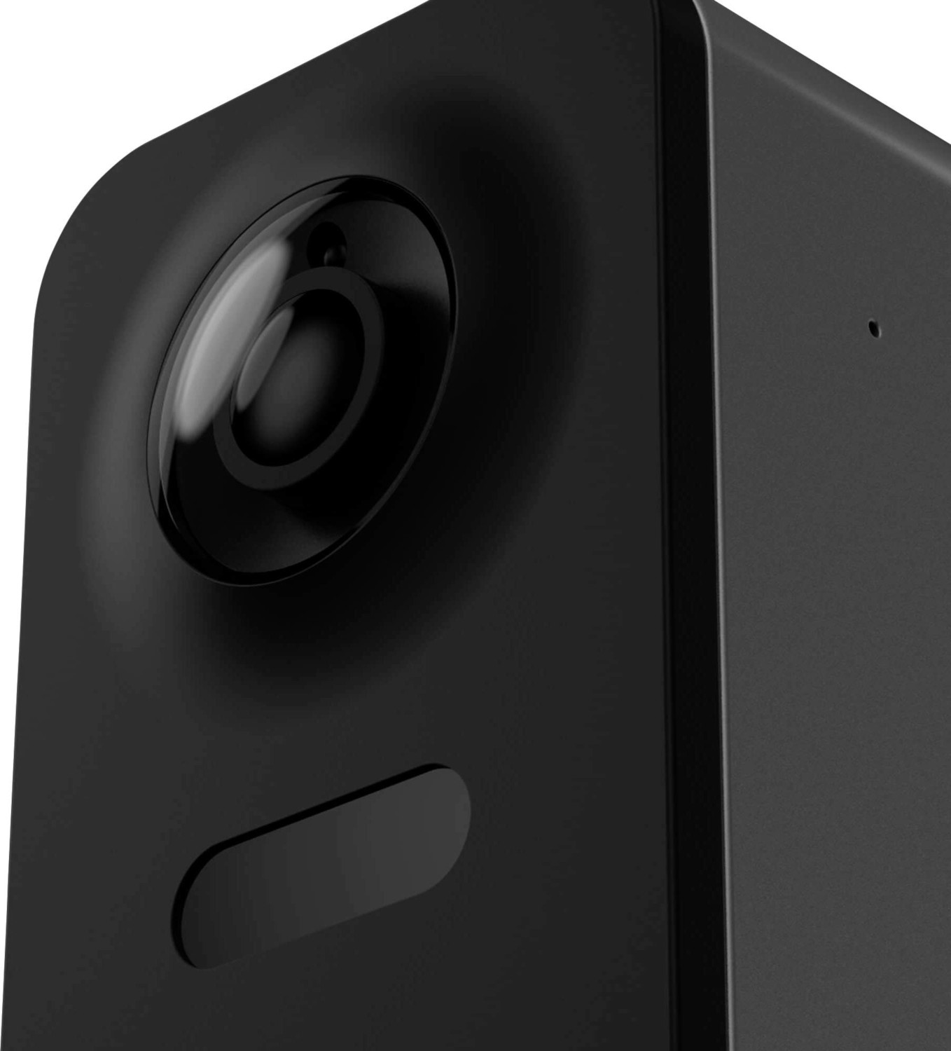 A black security camera with a lens and a button, close up.