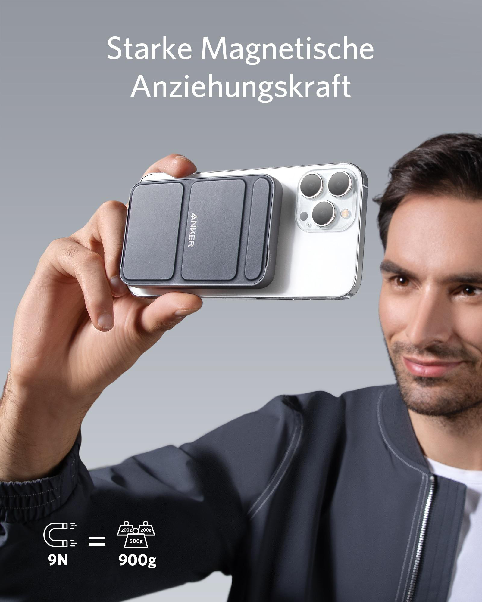 Ein Mann hält ein Telefon mit einer grauen magnetischen Powerbank. Text: 'Starke Magnetische Anziehungskraft'.