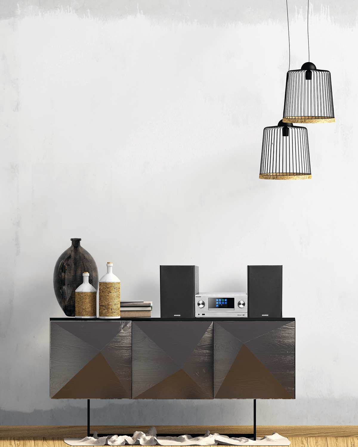 A cabinet with speakers and a stereo. Two lamps hanging above. White wall in the background.