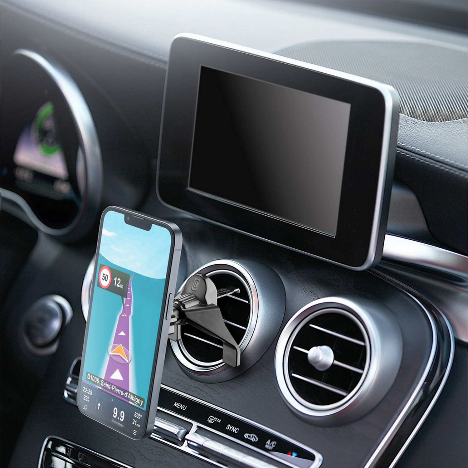 Car interior: phone in holder showing map, screen above it. Dashboard details visible.
