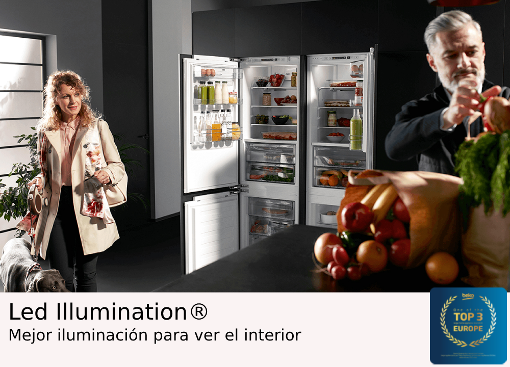 Un refrigerador con puertas abiertas, una mujer, un hombre y un perro en un entorno de cocina.