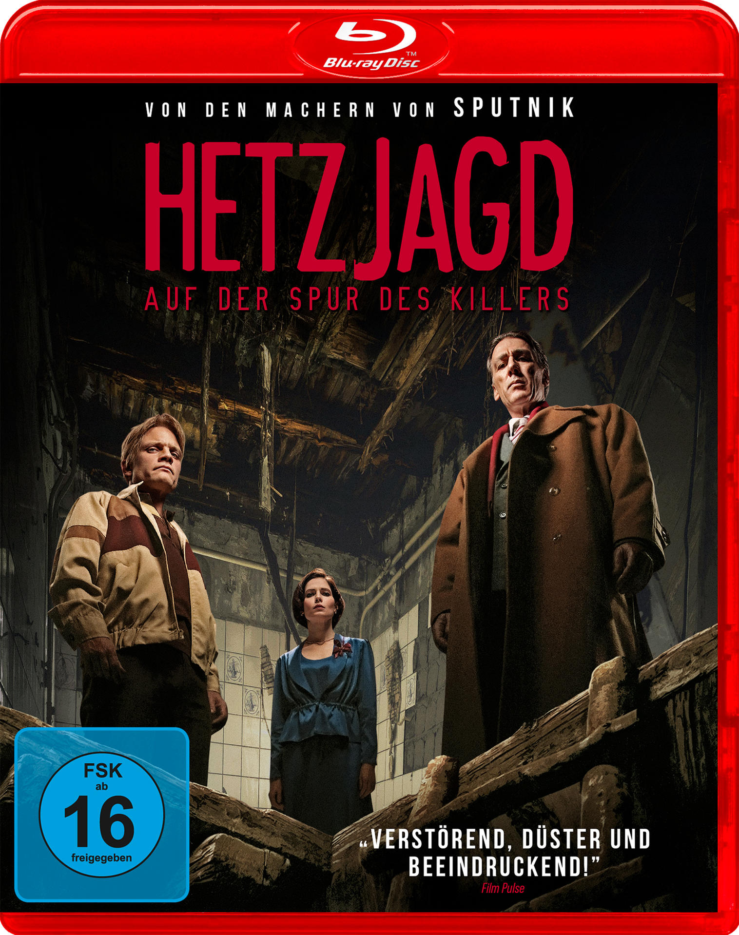 Blu-ray-Cover für Hetzjagd. Drei Personen stehen in einem dunklen Innenraum. Der Titel ist rot. Das FSK 16-Logo befindet sich unten links.