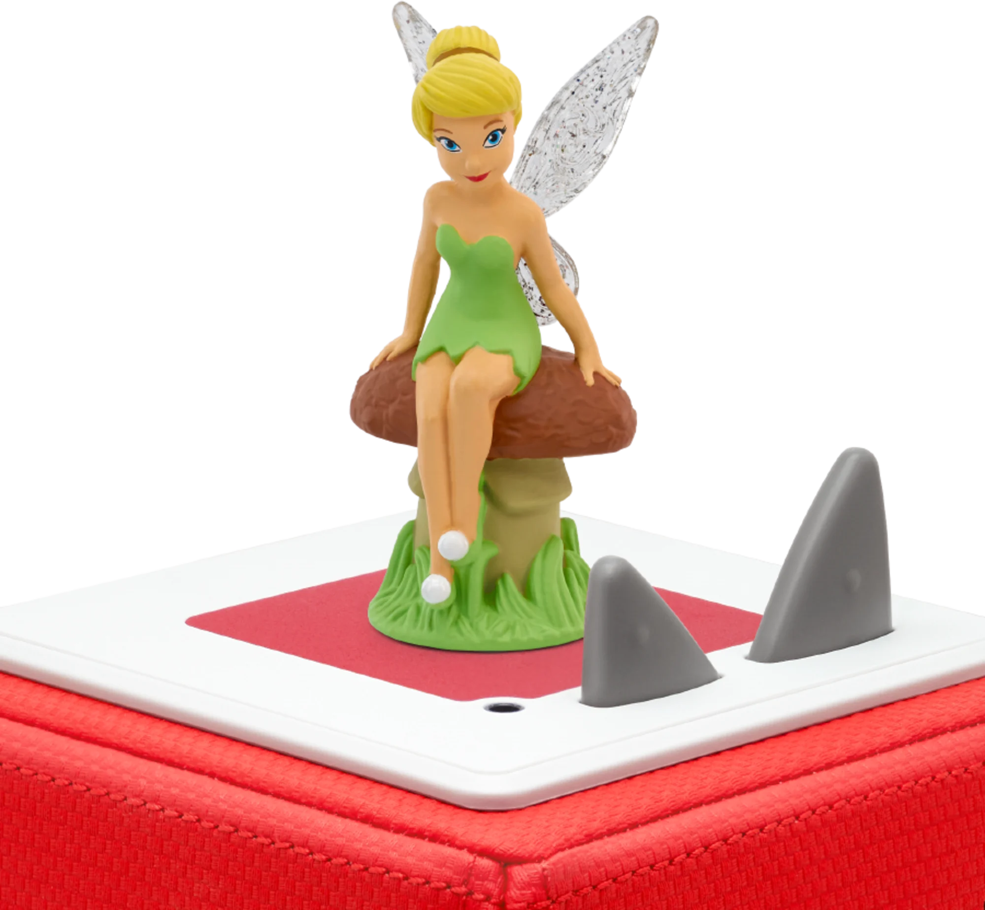 Tinkerbell-Figur sitzt auf einem Pilz, mit Haifischflossen auf roter und weißer Basis.