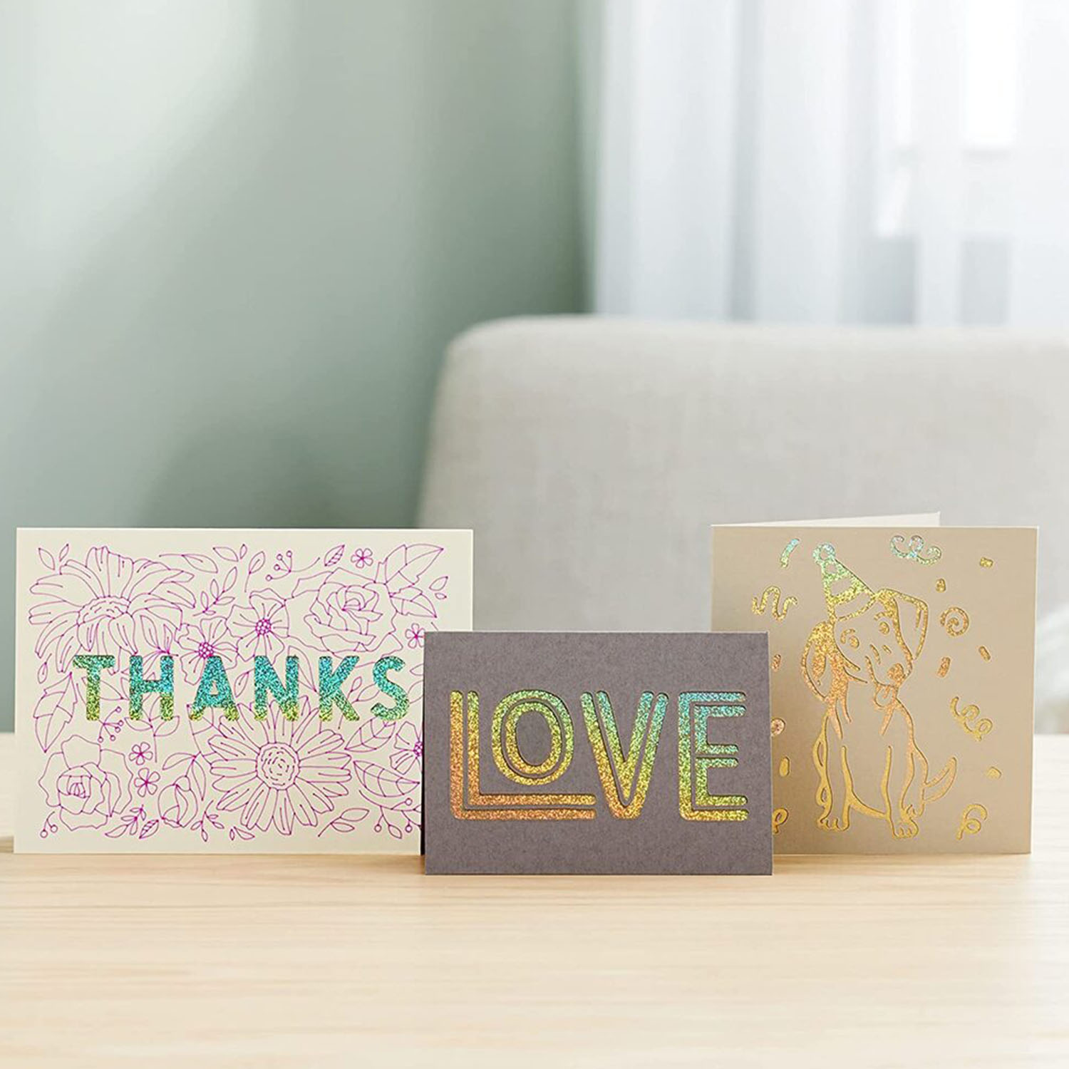 Tre biglietti di auguri: 'Grazie', 'Amore' e un biglietto con un cane. Tutti con disegni colorati.