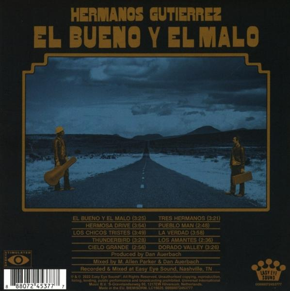 Albumcover, zwei Männer mit Instrumenten auf einer Straße, braune und gelbe Farben.